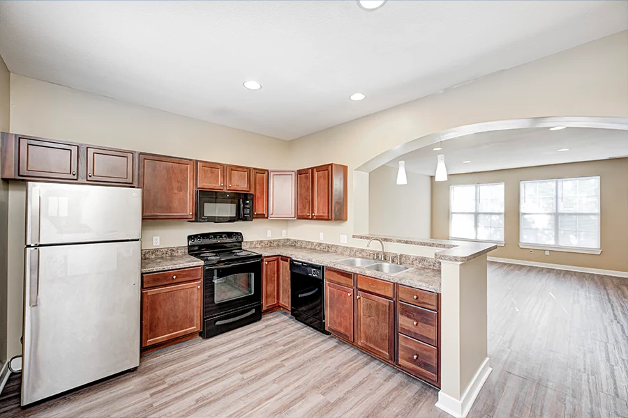 Choose a college apartment that has plenty of space for roommates and friends like this one at City Flats Renwick. A wide view of a roomy apartment kitchen and living space