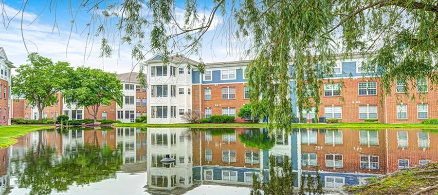 northhaven exterior with a reflective pond and weeping willow tree